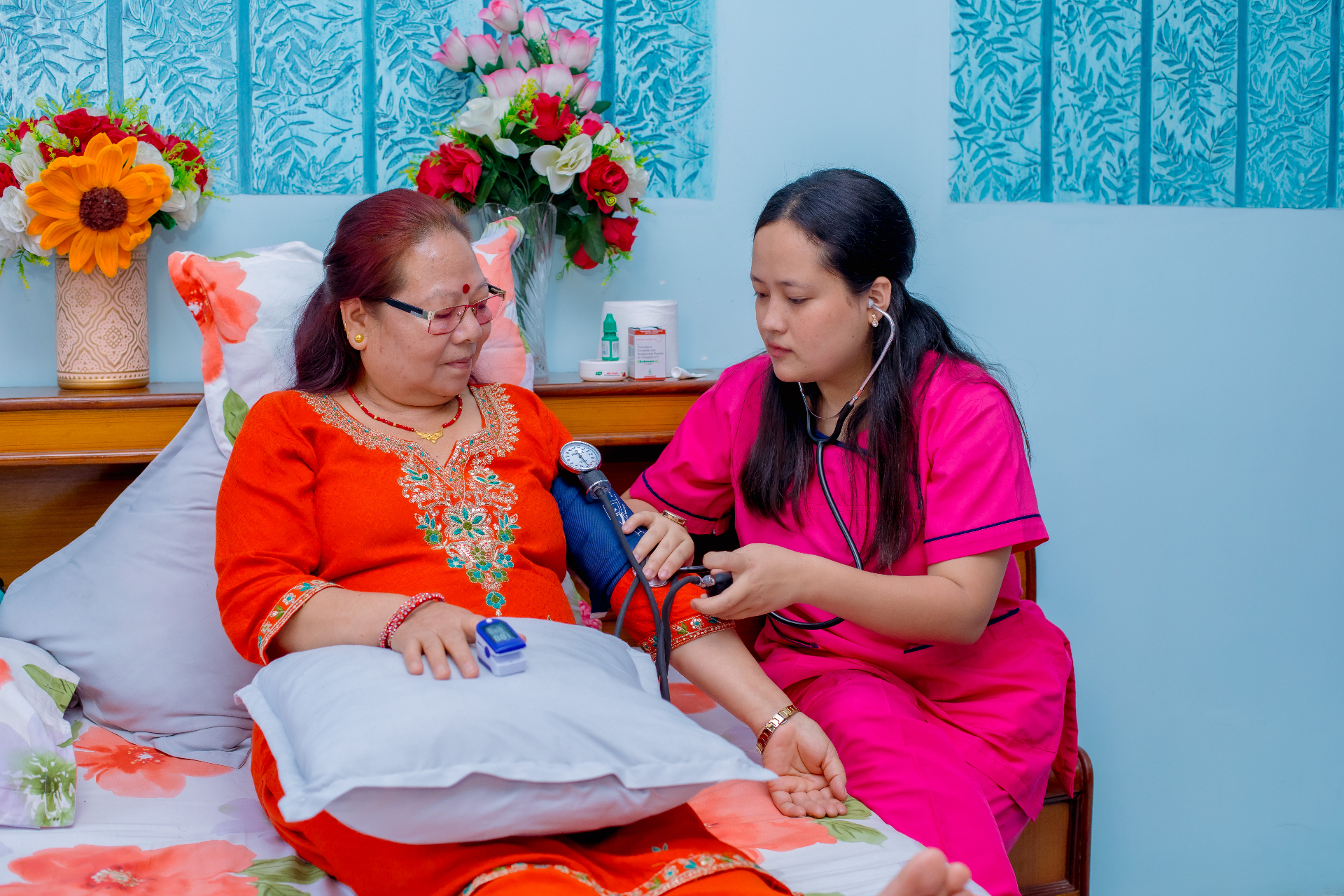 Nurse checking patient vitals during a home visit in Nepal
